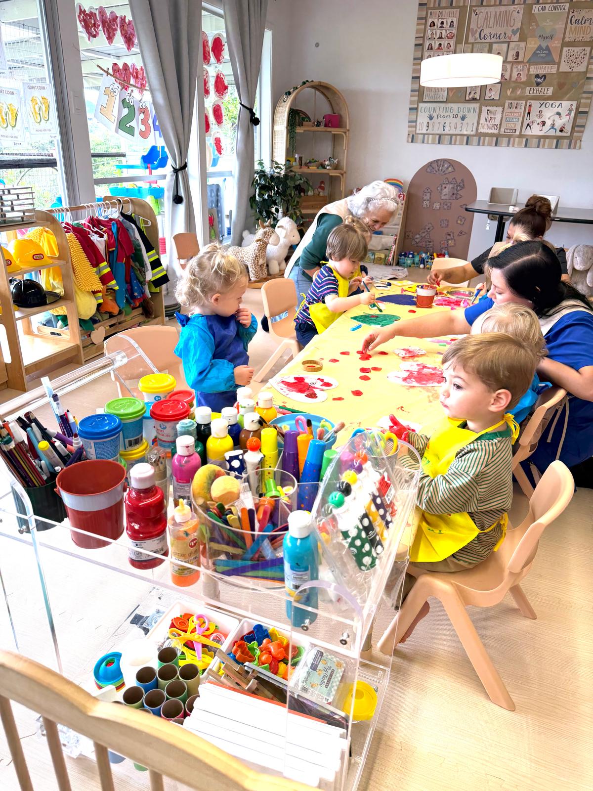 Children doing art activities with teacher at Discovery Time Daycare Greenbrae CA