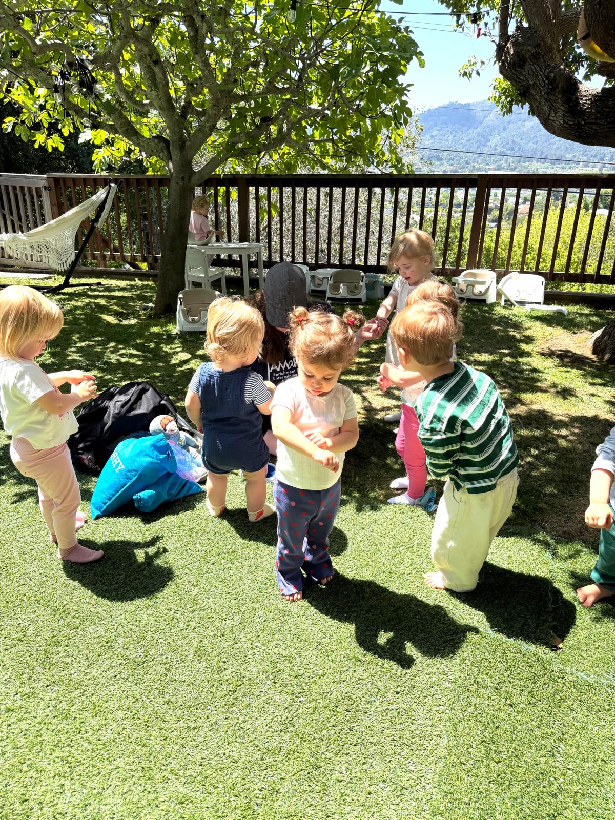 Toddlers playing outdoors at Discovery Time Daycare Greenbrae CA